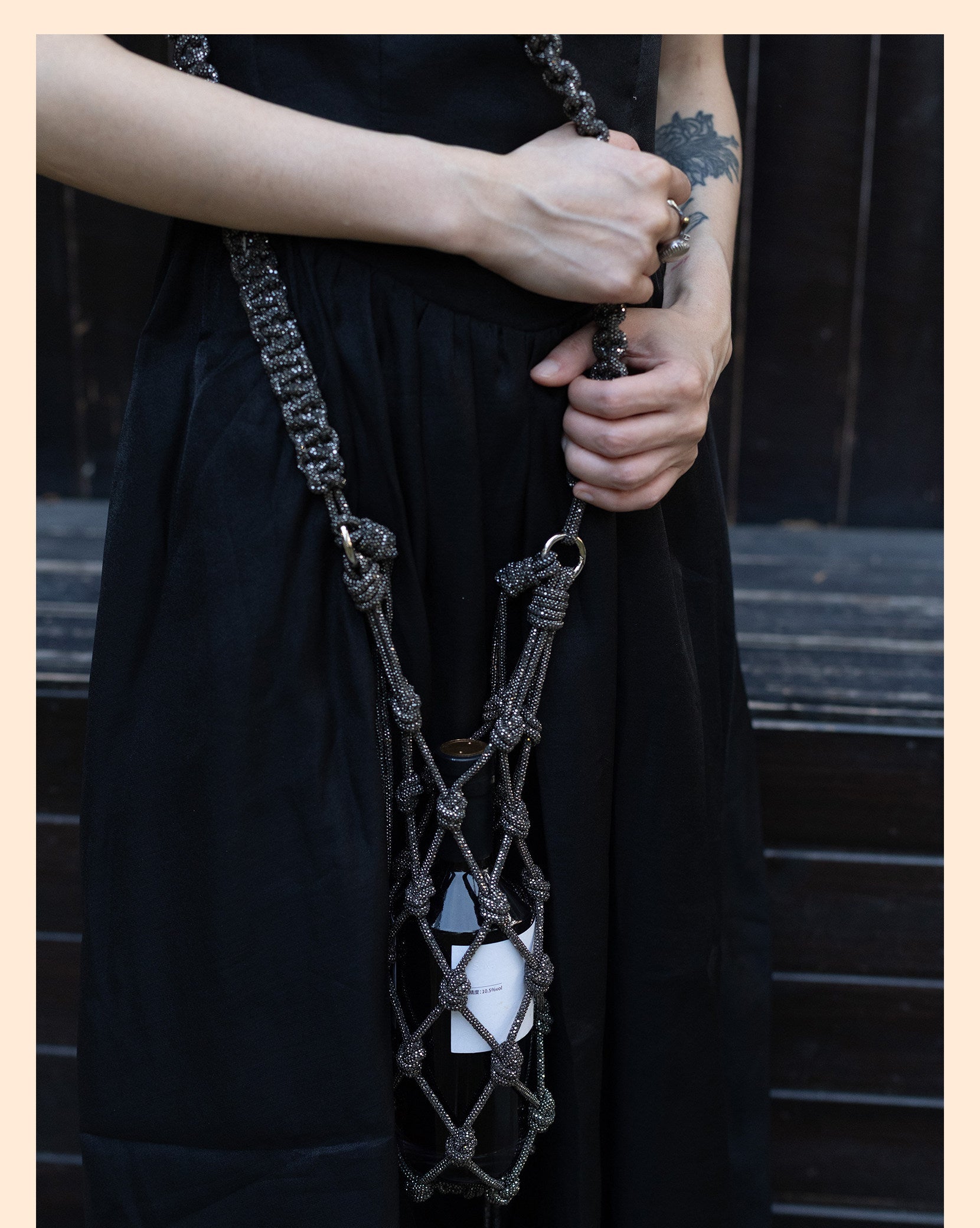 Elegant rhinestone wine tote bag with intricate knot design, perfect for luxury wine gifting and celebrations.