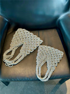Sparkling rhinestone wine tote bags for luxury gifts, weddings, and parties, displayed on a black leather chair.