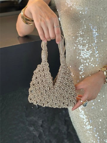 Hand holding beige macrame wine tote bag, perfect for luxury wine gifts and celebrations