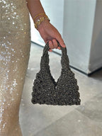 Sparkly rhinestone wine tote bag held by woman in sequin dress, perfect for luxury wine gifting
