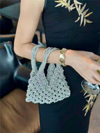 Sparkling rhinestone wine tote bag held by woman in black dress, perfect for luxury events and wine gifting.