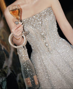 Elegant woman in sparkling gown holding champagne flute with rhinestone wine tote bag, perfect for luxury celebrations.
