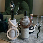 Luxury rhinestone wine bottle carriers with shell stoppers, perfect for elegant wine gifting and dinner parties.